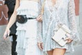 Women in white with Gucci pouch and white Hermes Constance bag before Trussardi fashion show, Milan Fashion Royalty Free Stock Photo