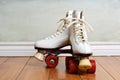 Women white quad roller skates on wood floor Royalty Free Stock Photo