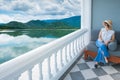 Women in white shirts, pants, weave hats Sitting and looking at the beautiful sea view from the window in the room Royalty Free Stock Photo