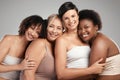 Women who stand together win together. a diverse group of women standing and hugging each other in the studio. Royalty Free Stock Photo