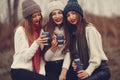 Women in a winter park without snow with thermos and tea Royalty Free Stock Photo