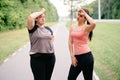 Women wiping sweat and rest after outdoor jogging Royalty Free Stock Photo