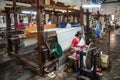 Women work in an old loom weaving cooperative in Kannur, and spinning wheel (Charkha), Kerala, India