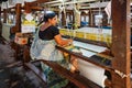 Women work in an old loom weaving cooperative in Kannur, Kerala, India