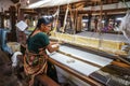 Women work in an old loom weaving cooperative in Kannur, Kerala, India