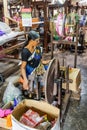 Women work in an old loom weaving cooperative in Kannur, and spinning wheel (Charkha), Kerala, India