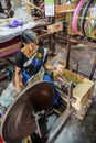 Women work in an old loom weaving cooperative in Kannur, and spinning wheel (Charkha), Kerala, India