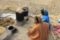 Women at work. Two women are husking paddy. Royalty Free Stock Photo