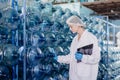 women worker working in drinking water factory inspect counting bottle gallon stock warehouse check counting with hygiene uniform Royalty Free Stock Photo