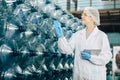 women worker working in drinking water plant factory checking count water bottle gallon in warehouse with hygiene uniform Royalty Free Stock Photo