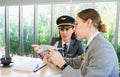 Women workers of airline work together, discus on airplane model, businesswomen wear pilot hat and look at airplane model