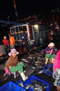 Women workers are collecting and sorting fisheries into baskets after a long day fishing in the Hon Ro seaport, Nha Trang city Royalty Free Stock Photo