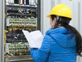 Women workers connect the network cable to the switch