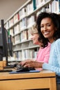 Women working on computers in library Royalty Free Stock Photo