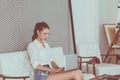 Woman working on laptop while lying on bed at home,Happy and smiling,Enjoying time,Working from home Royalty Free Stock Photo