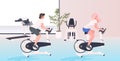 Women working out on stationary bike fitness cardio training workout healthy lifestyle concept