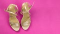 Women's beige sandals with rhinestones on high heels, on a pink background. Women's shoes. The view from the top Royalty Free Stock Photo