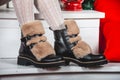 Women's black leather boots for winter. Warm shoes with fur lining. Concept of the coming winter, selling shoes for Royalty Free Stock Photo