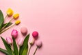 Top view photo of bouquets of pussy willow pink yellow and pink tulips on isolated pastel blue background with copyspace