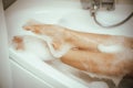 Women& x27;s feet in bath foam. View from above. Enjoy and relax in a spa hotel Royalty Free Stock Photo