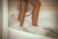 Women's feet in bath foam. View from above. Enjoy and relax in a spa hotel Royalty Free Stock Photo