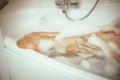 Women& x27;s feet in bath foam. View from above. Enjoy and relax in a spa hotel Royalty Free Stock Photo