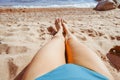 women& x27;s feet on the beach by the sea Royalty Free Stock Photo