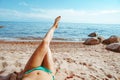 women& x27;s feet on the beach by the sea Royalty Free Stock Photo