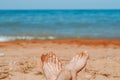 women's feet on the beach by the sea Royalty Free Stock Photo