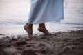 Women& x27;s feet in the river. Close-up side view of a young woman& x27;s bare feet on a sandy river beach at sunset Royalty Free Stock Photo