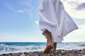 Women& x27;s feet in the sea. Close-up side view of a young woman& x27;s bare feet on a sandy sea beach at sunset. Royalty Free Stock Photo