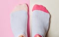 Women& x27;s feet with socks on a pastel colored background. Top view, minimalism.