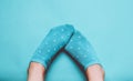 Women& x27;s feet with socks on a pastel colored background. Top view, minimalism.