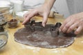 Women& x27;s hands cooking festive Christmas gingerbread cookies. Cooking chocolate cookies or dessert Royalty Free Stock Photo