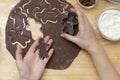 Women& x27;s hands cooking festive Christmas gingerbread cookies. Cooking chocolate cookies or dessert Royalty Free Stock Photo