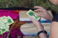 Women& x27;s hands hold a divination card during a spiritual practice session in nature. The concept of yoga, female strength Royalty Free Stock Photo