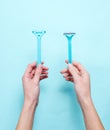 Women& x27; s hands hold two shaving razor Royalty Free Stock Photo