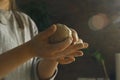 Women& x27;s hands knead and beat a clay ball to make ceramic products.