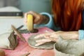 Women& x27;s hands knead the clay and sculpt a cup or bowl from it. The process of manufacturing a ceramic product,close