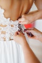 Women& x27;s hands lace up the lace corset of the bride& x27;s wedding dress. Close-up Royalty Free Stock Photo