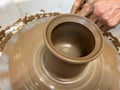 Women's hands making a kitchen object from clay on a potter's wheel manual potter wheel is rotated on a vertical Royalty Free Stock Photo