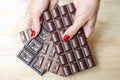 Women's hands, offering a choice of different chocolate bars - black, milk and porous chocolate Royalty Free Stock Photo