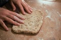 Women& x27;s hands roll out dough from whole grain flour. Making homemade bread Royalty Free Stock Photo