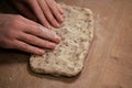 Women& x27;s hands roll out dough from whole grain flour. Making homemade bread Royalty Free Stock Photo