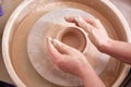women& x27;s hands work on a potter& x27;s wheel, sculpt a bowl of raw clay. Royalty Free Stock Photo