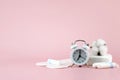 Women's menstrual pads, tampons, female menstruation calendar and alarm clock on a pink background. Royalty Free Stock Photo