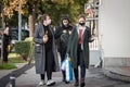 Women, young girls, walking with groceries, including food, toilet paper and wine wearing face mask respiration equipment