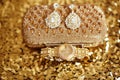 Womens accessories. Fashion diamond earrings and golden wristwatch. Sparkling Jewelry Shiny Crystal Precious Gem Jewel