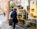 Womens admiring sweets in French bakery cafe store