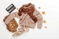 Womens autumn stylish outfit Sweater and scarf Earth brown Colour set On white background flat lay With copy space. Set